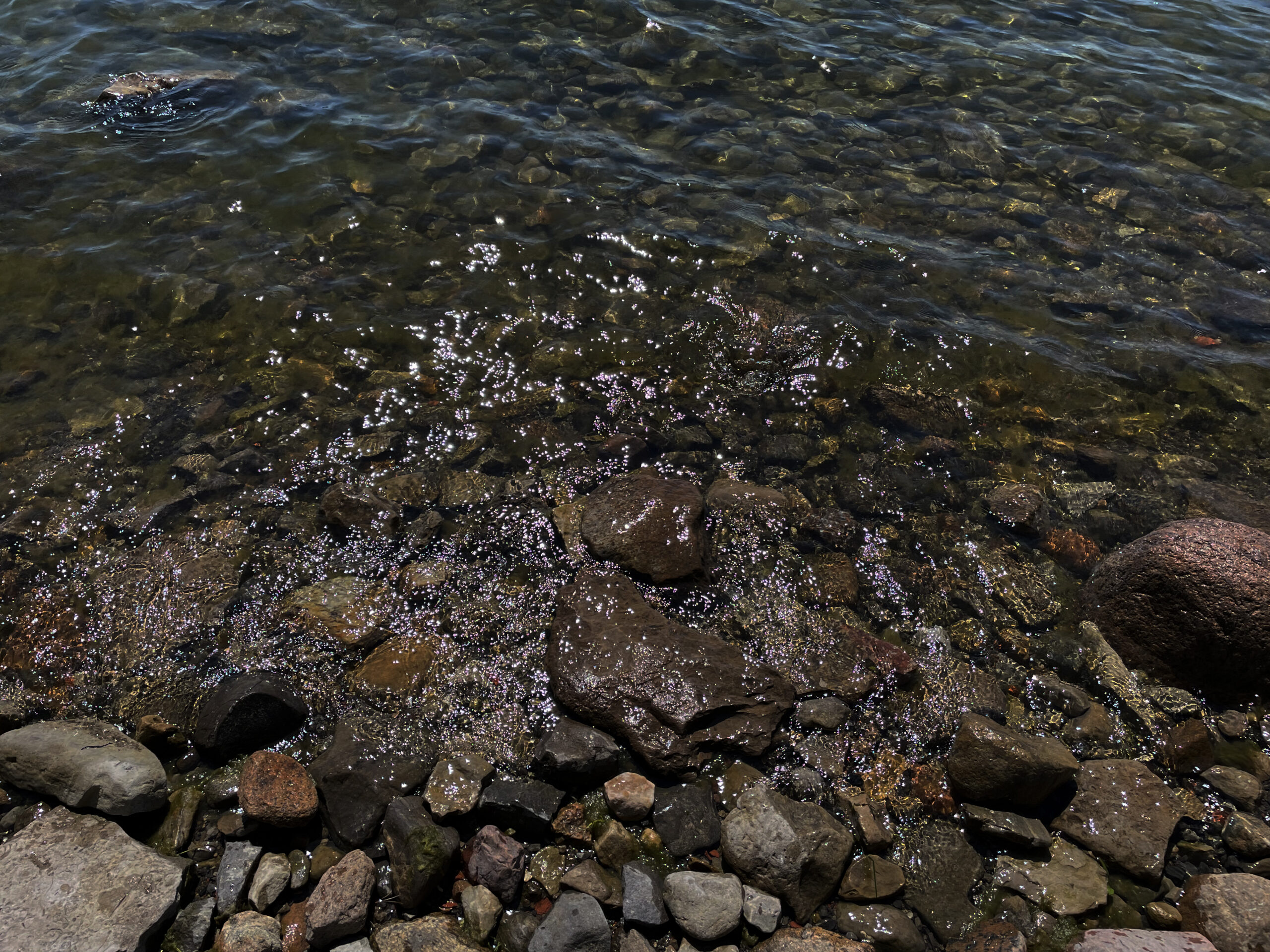 Rocky shoreline with water rising between the rocks.